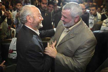 Palestinian Prime Minister Ismail Haniyeh (right) greets British MP George Galloway in Gaza