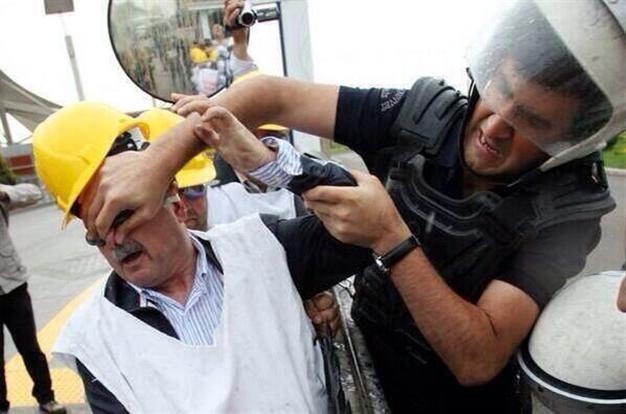 The image above of a police officer pinching the nose of a worker sparked huge outrage, triggering a social media campaign with the hashtag 'Yatagan is not alone' (#YataganYalnizDegildir).