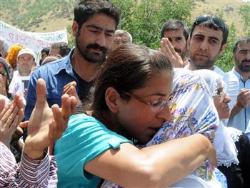 Ethem Sarisülük's sister-in-law Yonca (L) hug Medeni Yildirim's mother Fehriye (R) in Diyarbakir's Lice district. DHA photo