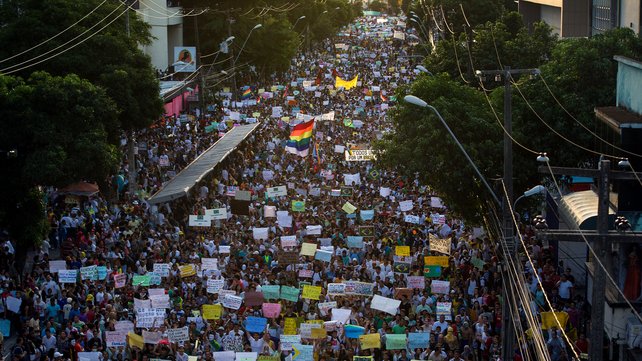Thousands of people march on Avenida Conde Boa Vista, in the state of Pernambuco, Brazil